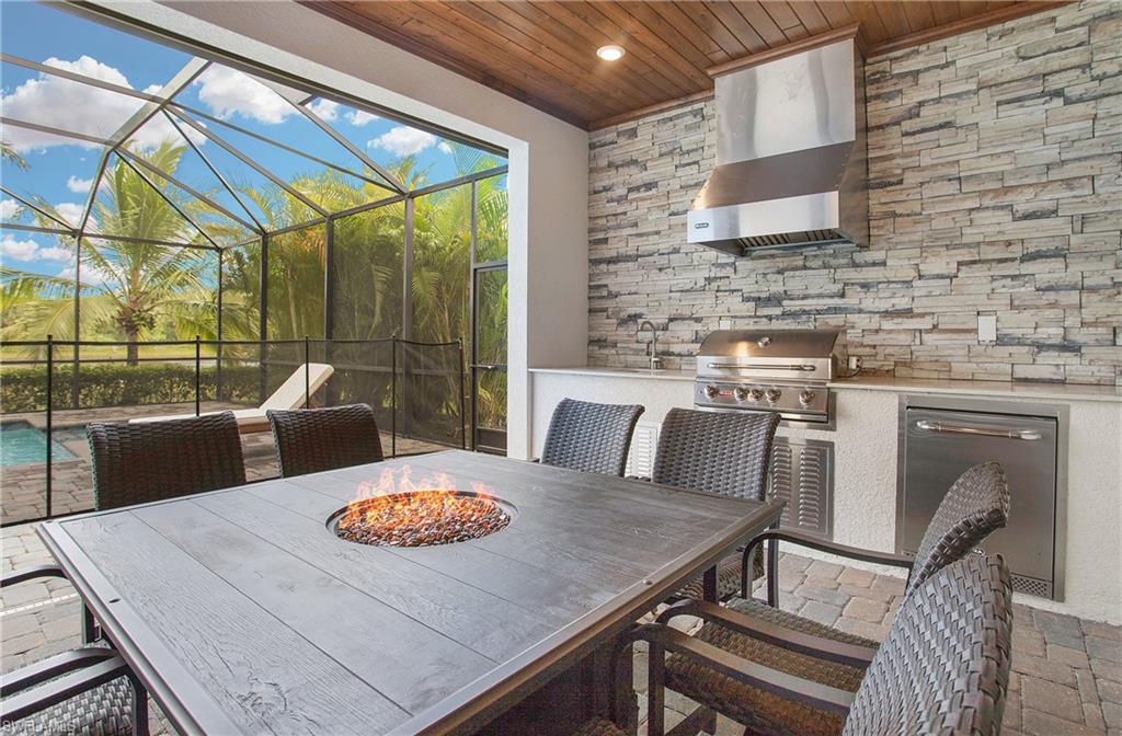 2247 Somerset Place Naples, FL 34120 - Photo 27 of 35 a view of a dining room with furniture window and wooden floor
