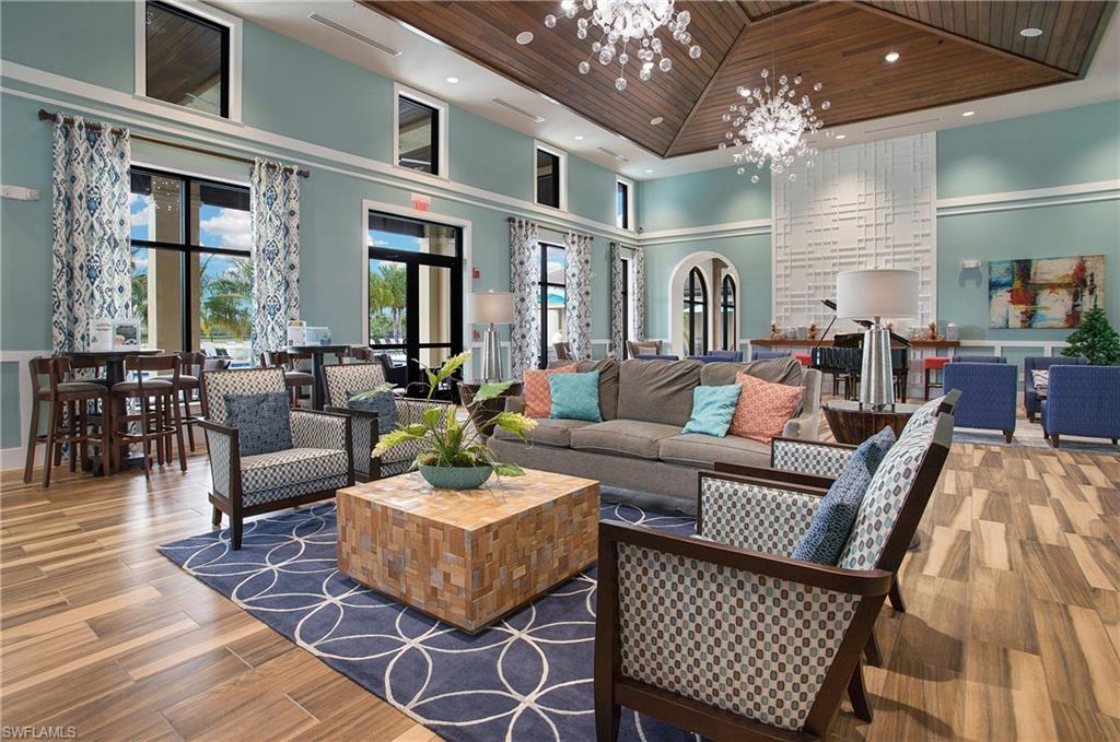 2247 Somerset Place Naples, FL 34120 - Photo 31 of 35 a living room with furniture dining area and a chandelier