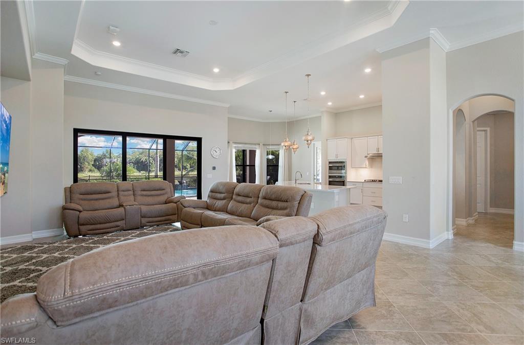 2247 Somerset Place Naples, FL 34120 - Photo 4 of 35 a living room with furniture and a floor to ceiling window