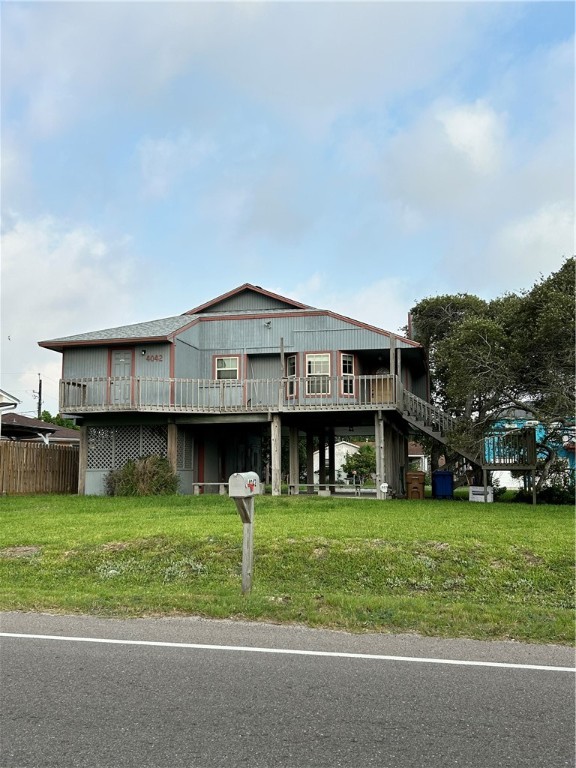 4042 Laguna Shores Road Corpus Christi, TX 78418 - Photo 2 of 25 a view of a big house with a big yard and large trees