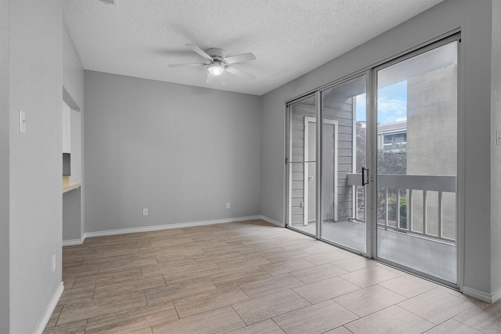 5310 Keller Springs Road, Unit 626 Dallas, TX 75248 - Photo 5 of 13 a view of an empty room with wooden floor and a window