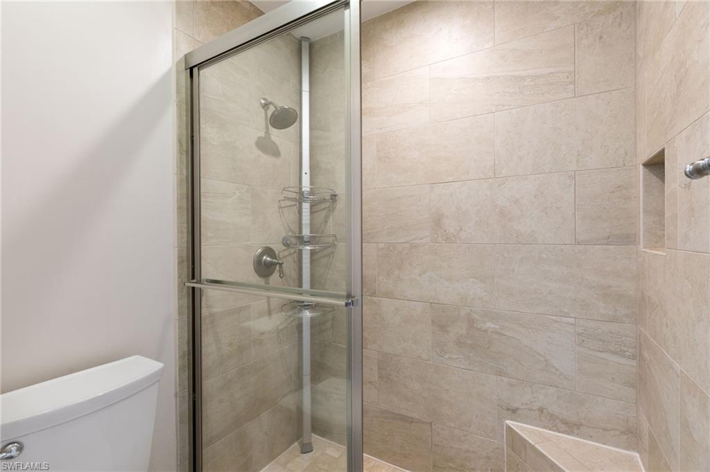 3346 Erick Lake Drive, Unit 2001 Naples, FL 34109 - Photo 19 of 43 a bathroom with a shower and toilet