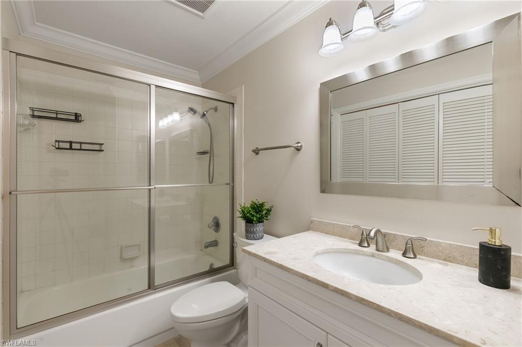 3346 Erick Lake Drive, Unit 2001 Naples, FL 34109 - Photo 22 of 43 a bathroom with a granite countertop sink toilet and shower