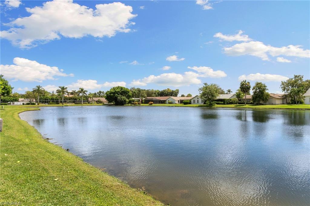 3346 Erick Lake Drive, Unit 2001 Naples, FL 34109 - Photo 27 of 43 a view of a lake with houses in the background