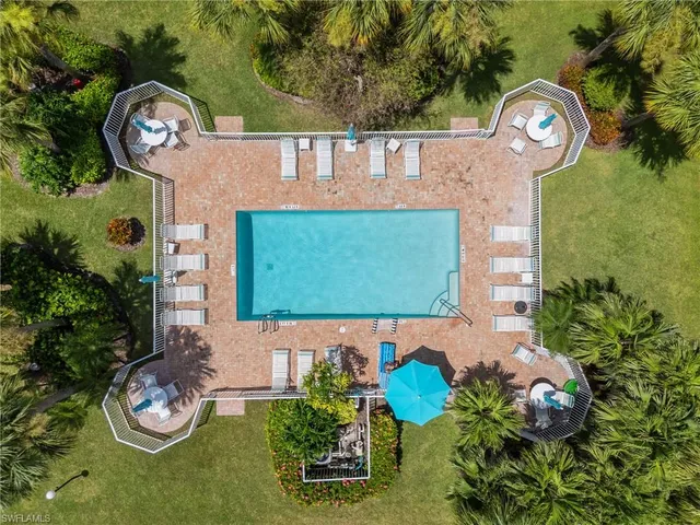 a front view of a house with garden and a chandelier