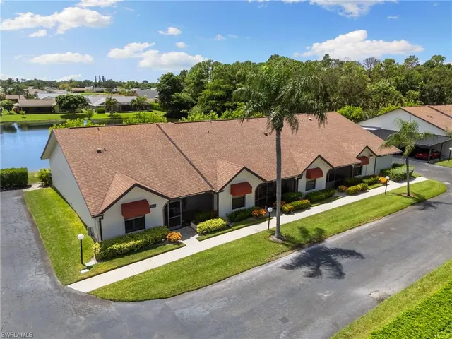 an aerial view of a house with swimming pool and a yard