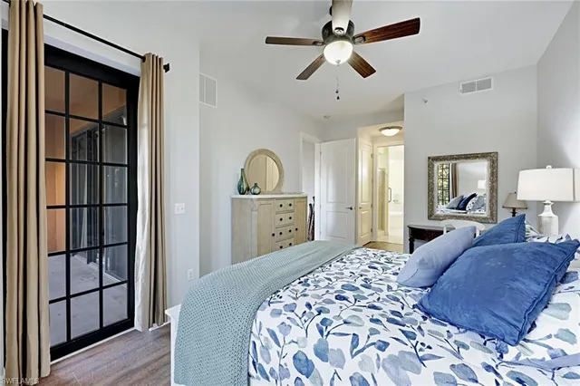 a bedroom with a large bed and a chandelier