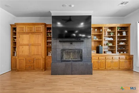 a living room with furniture kitchen view and a chandelier