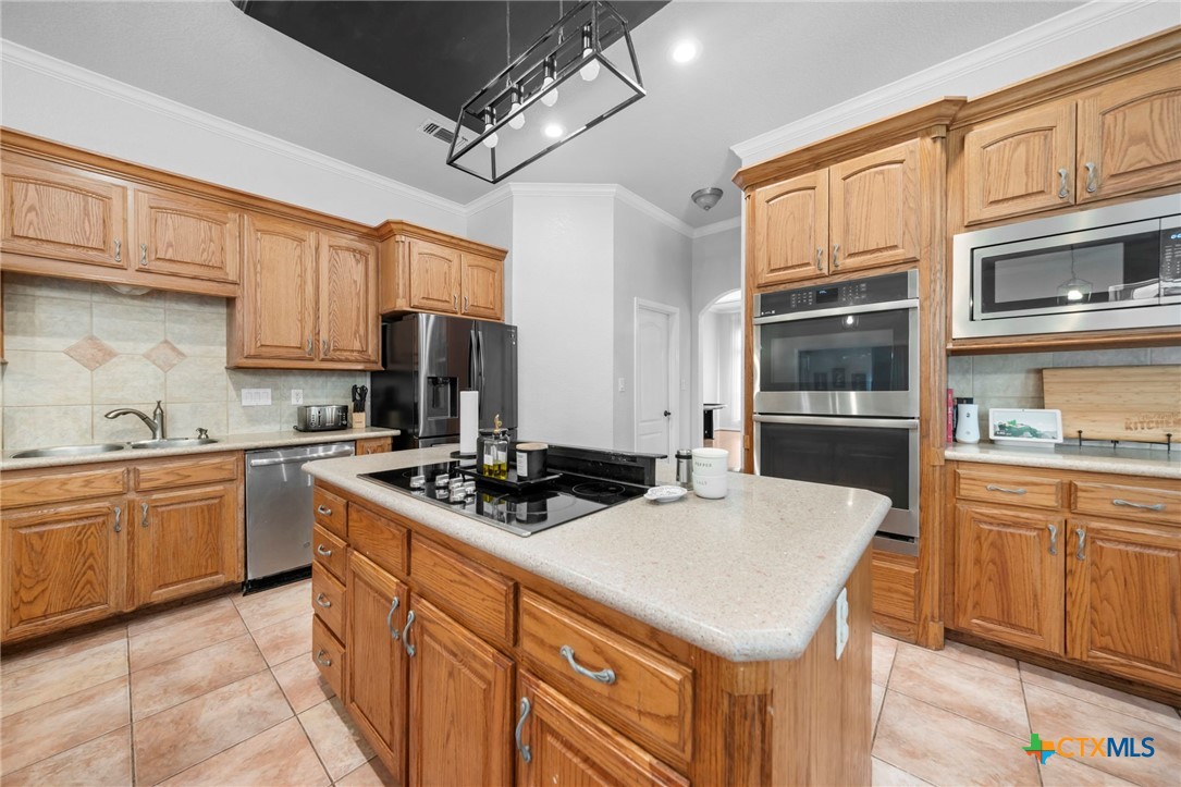 2383 Pecan Creek Road Killeen, TX 76549 - Photo 17 of 39 a kitchen with stainless steel appliances granite countertop a sink stove and refrigerator