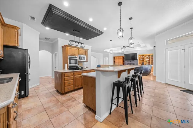 a view of a living room kitchen and windows