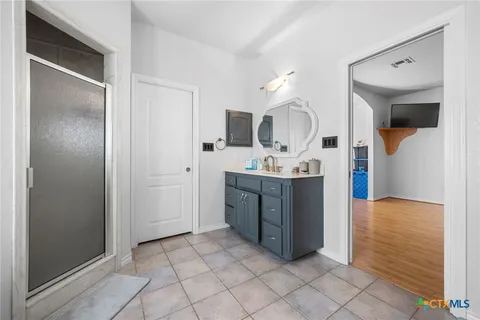 a large white kitchen with a sink and cabinets