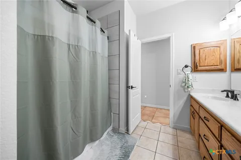 a spacious bedroom with a bed and wooden floor