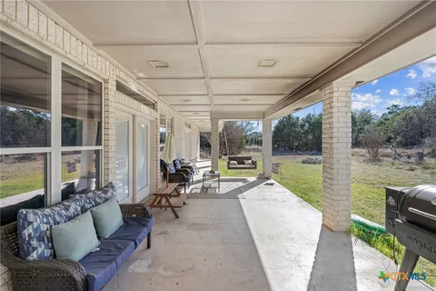 a view of a room with windows and wooden floor