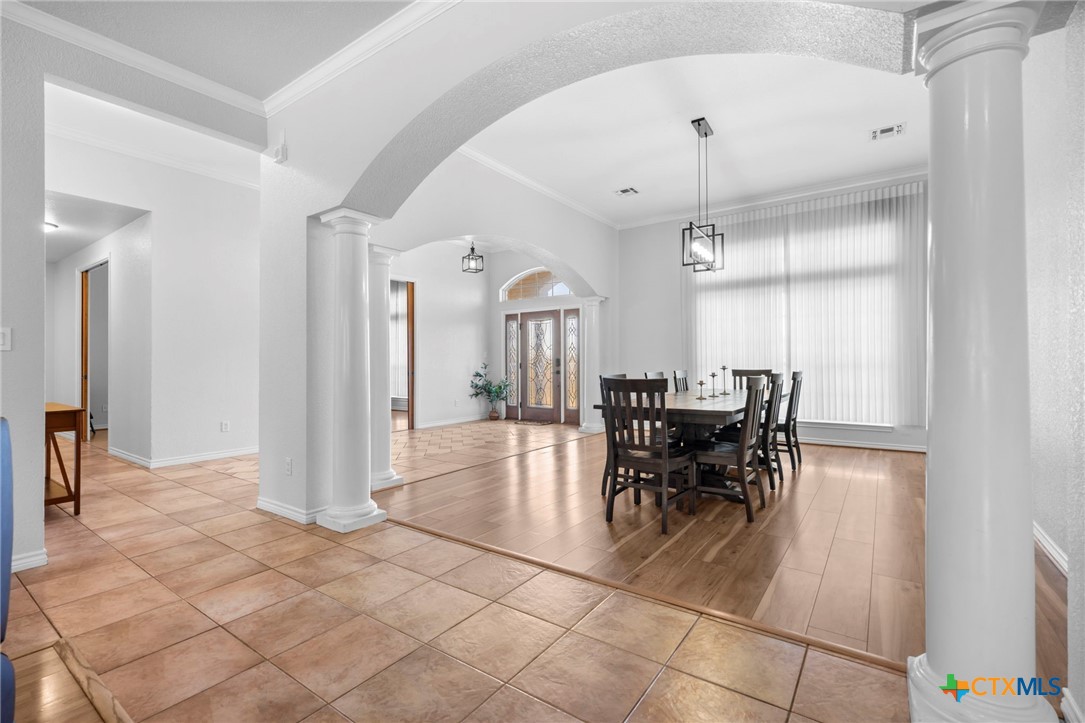 2383 Pecan Creek Road Killeen, TX 76549 - Photo 7 of 39 a view of a dining room with furniture and a chandelier fan