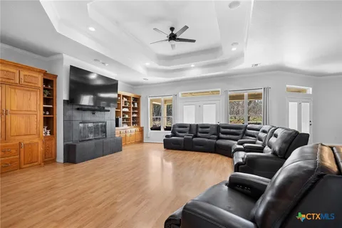 a living room with fireplace furniture and a flat screen tv