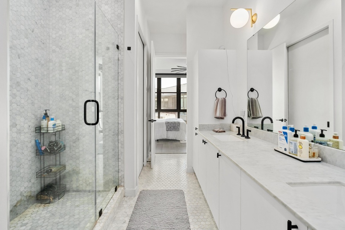 800 Embassy Drive, Unit 609 Austin, TX 78702 - Photo 11 of 33 a bathroom with a double vanity sink mirror and shower