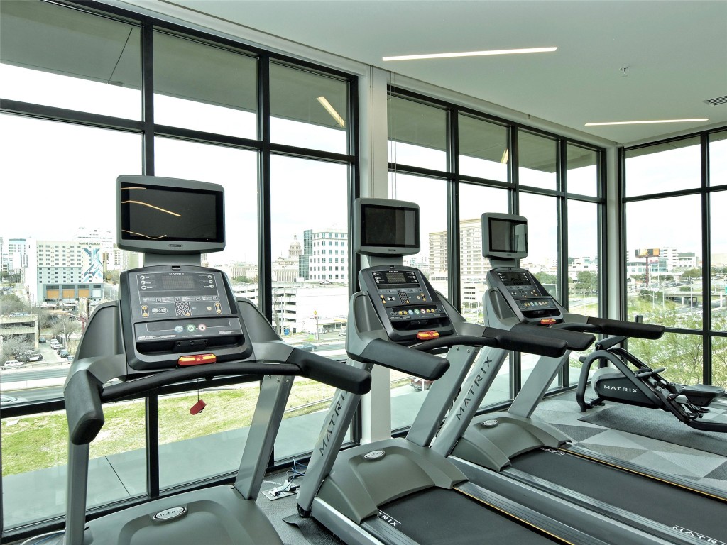 800 Embassy Drive, Unit 609 Austin, TX 78702 - Photo 26 of 33 a view of a living room with furniture and floor to ceiling windows
