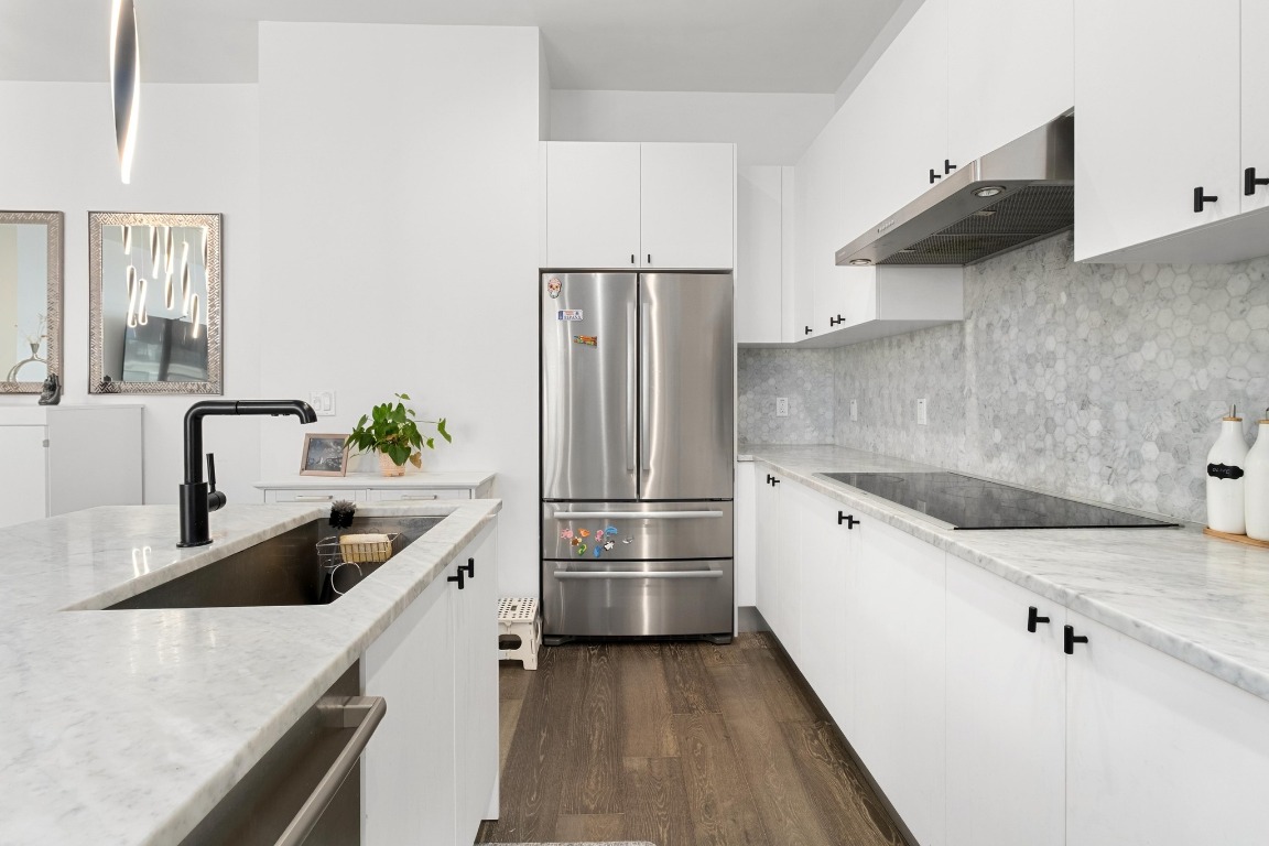 800 Embassy Drive, Unit 609 Austin, TX 78702 - Photo 6 of 33 a kitchen with granite countertop a refrigerator and a sink