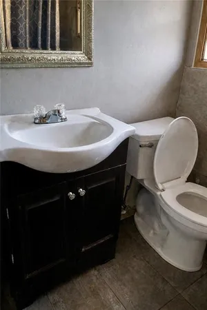 a bathroom with a sink toilet and mirror