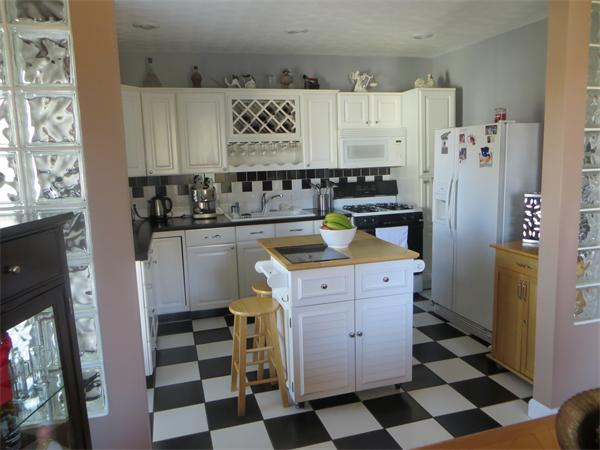 150 Dover Street Fall River, MA 02721 - Photo 12 of 30 a kitchen with a sink a refrigerator and cabinets