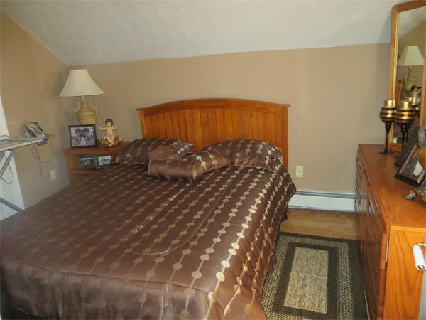 150 Dover Street Fall River, MA 02721 - Photo 16 of 30 a bedroom with a bed and a dresser with wooden floor