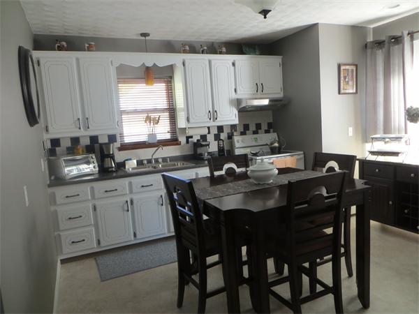 150 Dover Street Fall River, MA 02721 - Photo 2 of 30 a kitchen with a table chairs sink and cabinets