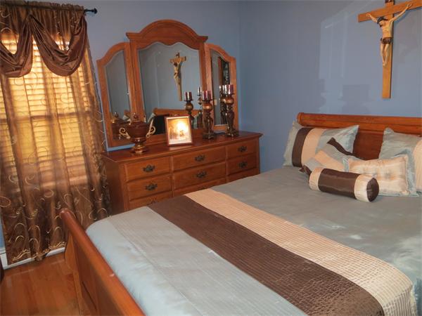 150 Dover Street Fall River, MA 02721 - Photo 4 of 30 a room with a bed and a mirror on dresser