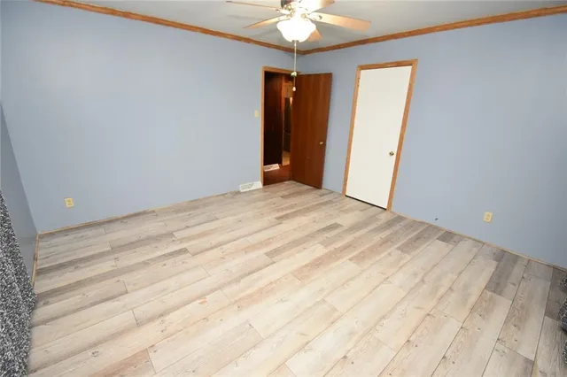 a view of a room with closet and chandelier fan