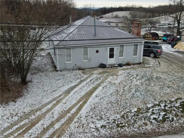 a aerial view of a house with a yard
