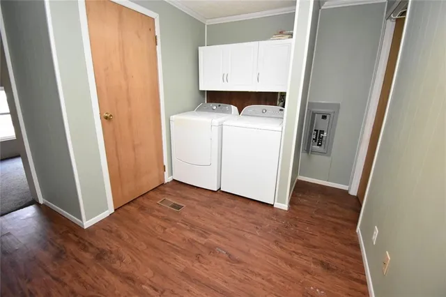 a view of washer and dryer with wooden floor