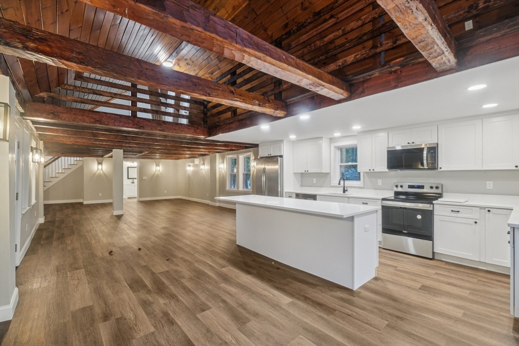 1 Rounseville Road Rochester, MA 02770 - Photo 17 of 42 a kitchen with stainless steel appliances granite countertop a sink a stove and cabinets