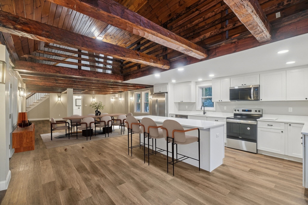 1 Rounseville Road Rochester, MA 02770 - Photo 18 of 42 a large white kitchen with lots of counter space a sink and chairs