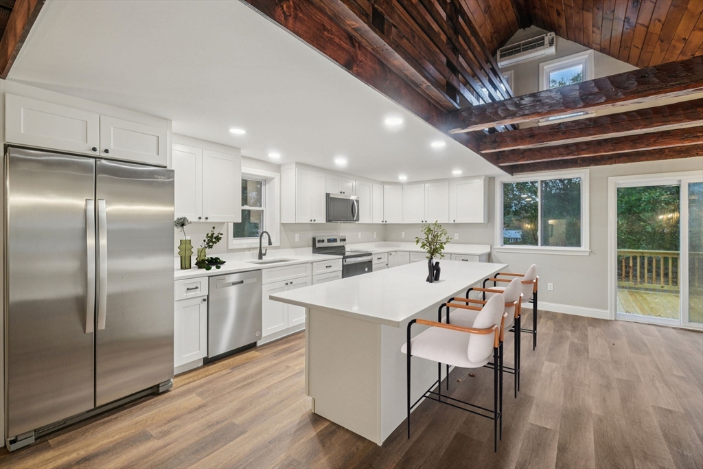1 Rounseville Road Rochester, MA 02770 - Photo 20 of 42 a kitchen with a sink a refrigerator and wooden floor