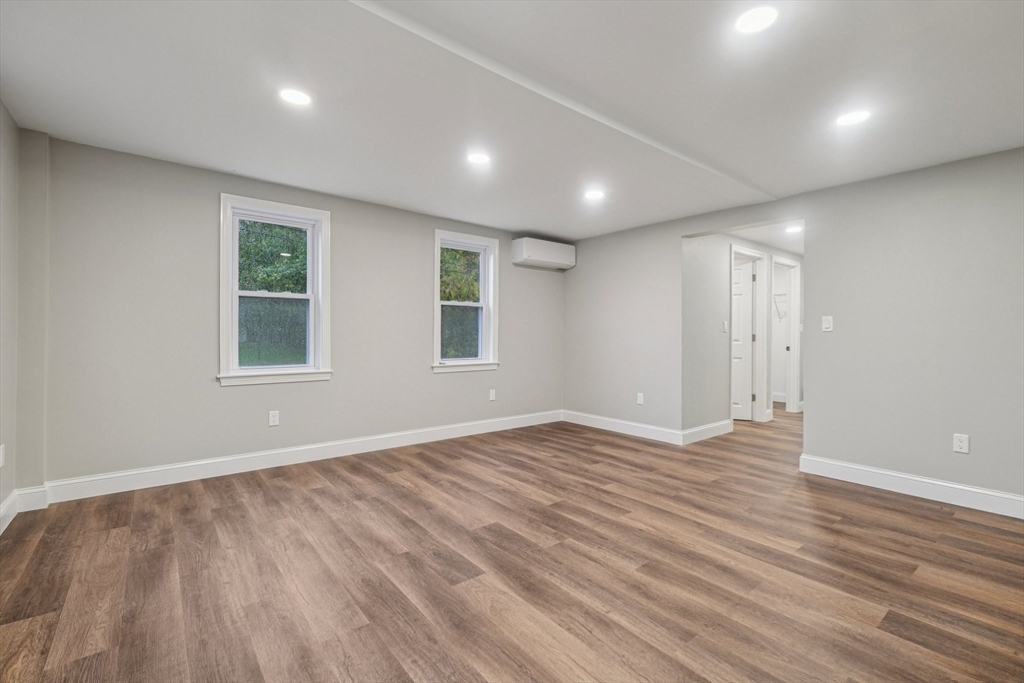 1 Rounseville Road Rochester, MA 02770 - Photo 24 of 42 an empty room with wooden floor and windows