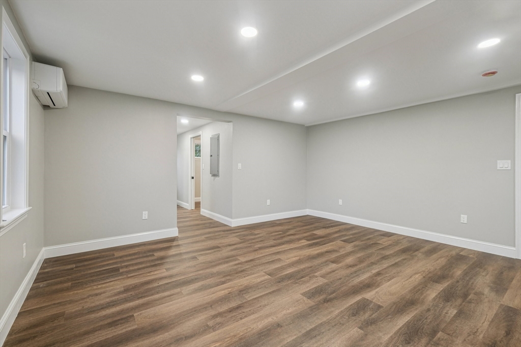 1 Rounseville Road Rochester, MA 02770 - Photo 25 of 42 a view of an empty room with wooden floor and a window