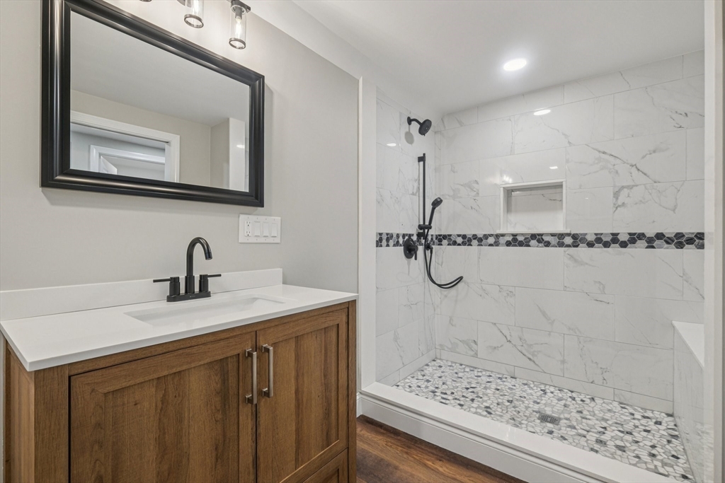 1 Rounseville Road Rochester, MA 02770 - Photo 27 of 42 a bathroom with a shower sink and mirror