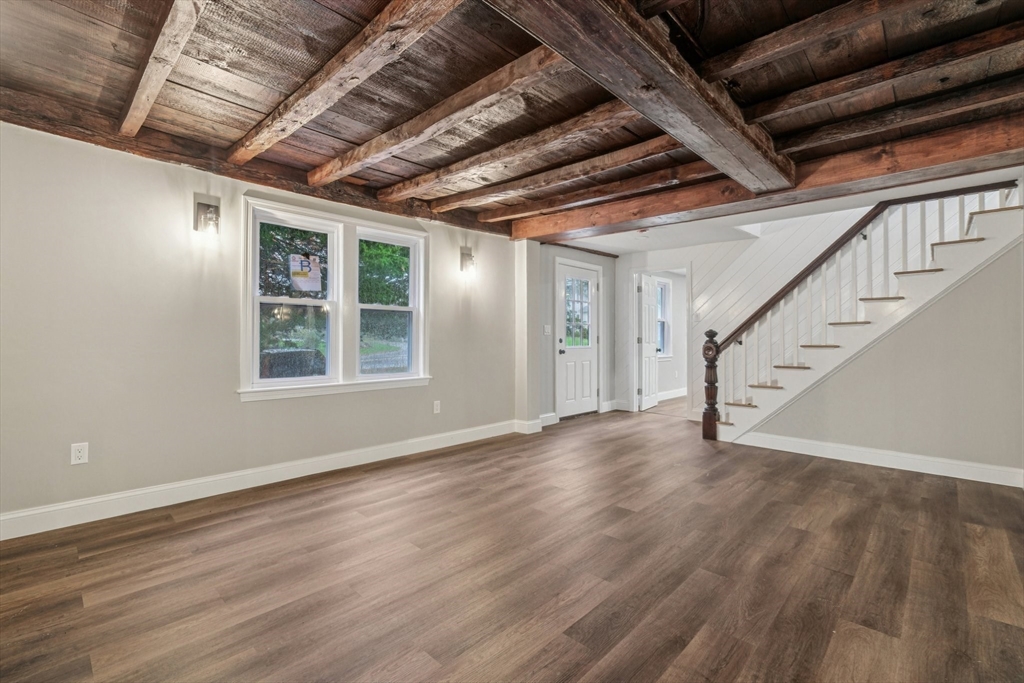 1 Rounseville Road Rochester, MA 02770 - Photo 7 of 42 a view of an empty room with wooden floor and stairs