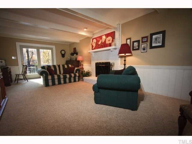 8305 Morgans Way Raleigh, NC 27613 - Photo 2 of 12 a living room with furniture and a fireplace