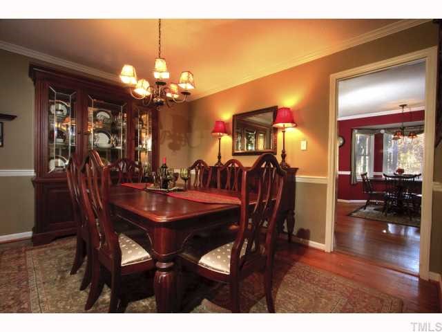8305 Morgans Way Raleigh, NC 27613 - Photo 3 of 12 a view of a dining room with furniture and chandelier