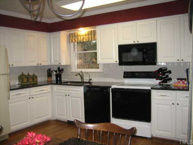 8305 Morgans Way Raleigh, NC 27613 - Photo 4 of 12 a kitchen with a sink cabinets and window