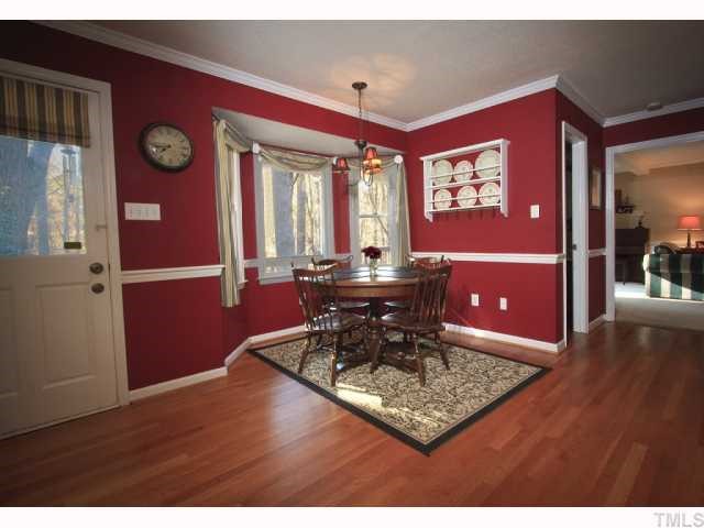 8305 Morgans Way Raleigh, NC 27613 - Photo 5 of 12 a view of a dining room with furniture and wooden floor