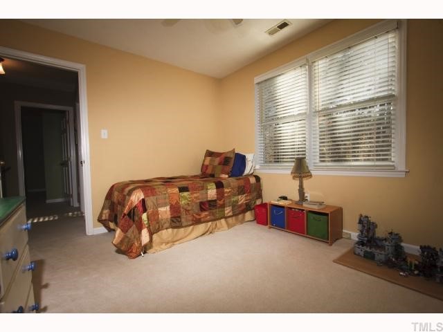 8305 Morgans Way Raleigh, NC 27613 - Photo 8 of 12 a bedroom with bed and a window