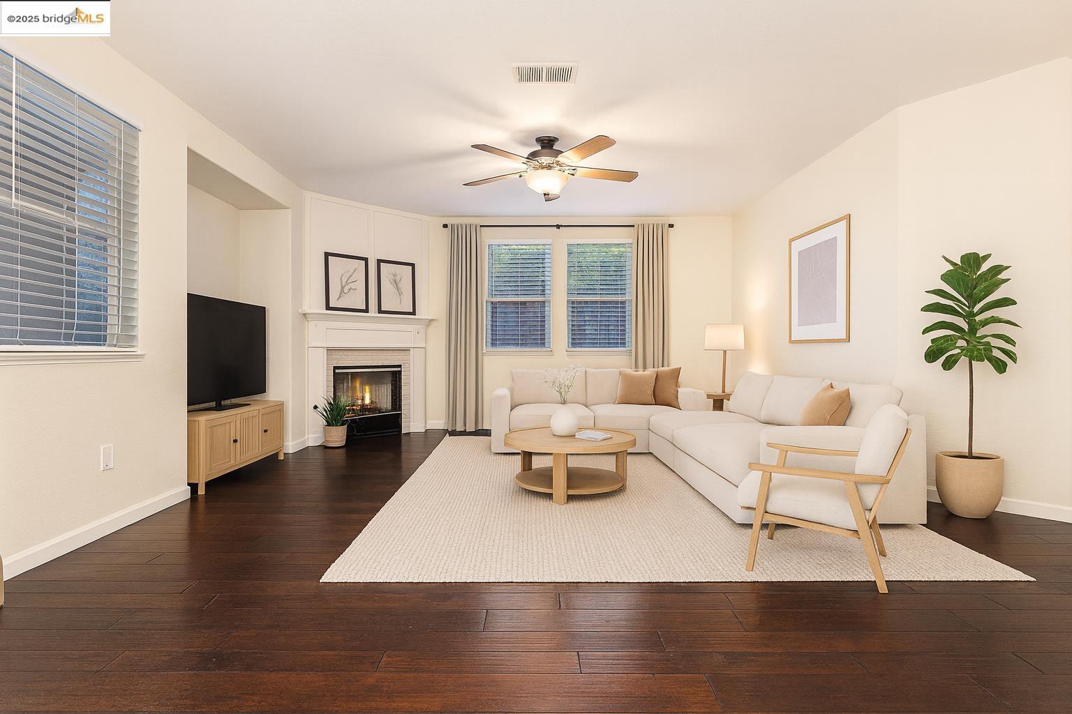 a living room with furniture a fireplace and a flat screen tv