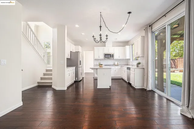 a view of kitchen with furniture and wooden floor