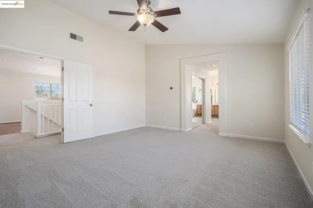 an empty room with windows and closet