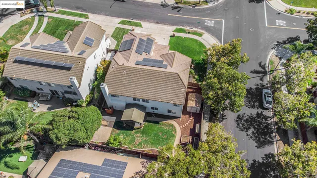 an aerial view of a house with a yard and potted plants