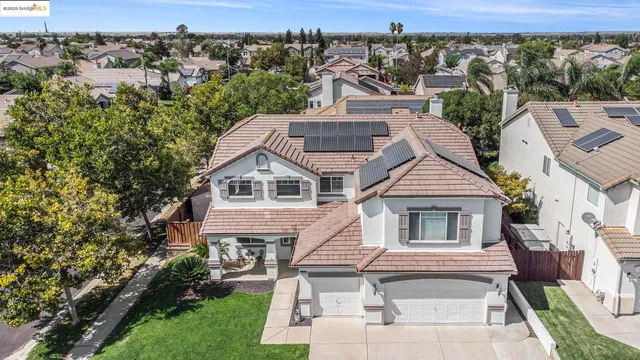 an aerial view of a house with a yard