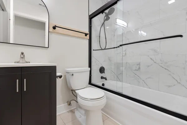 a bathroom with a toilet a sink and a shower