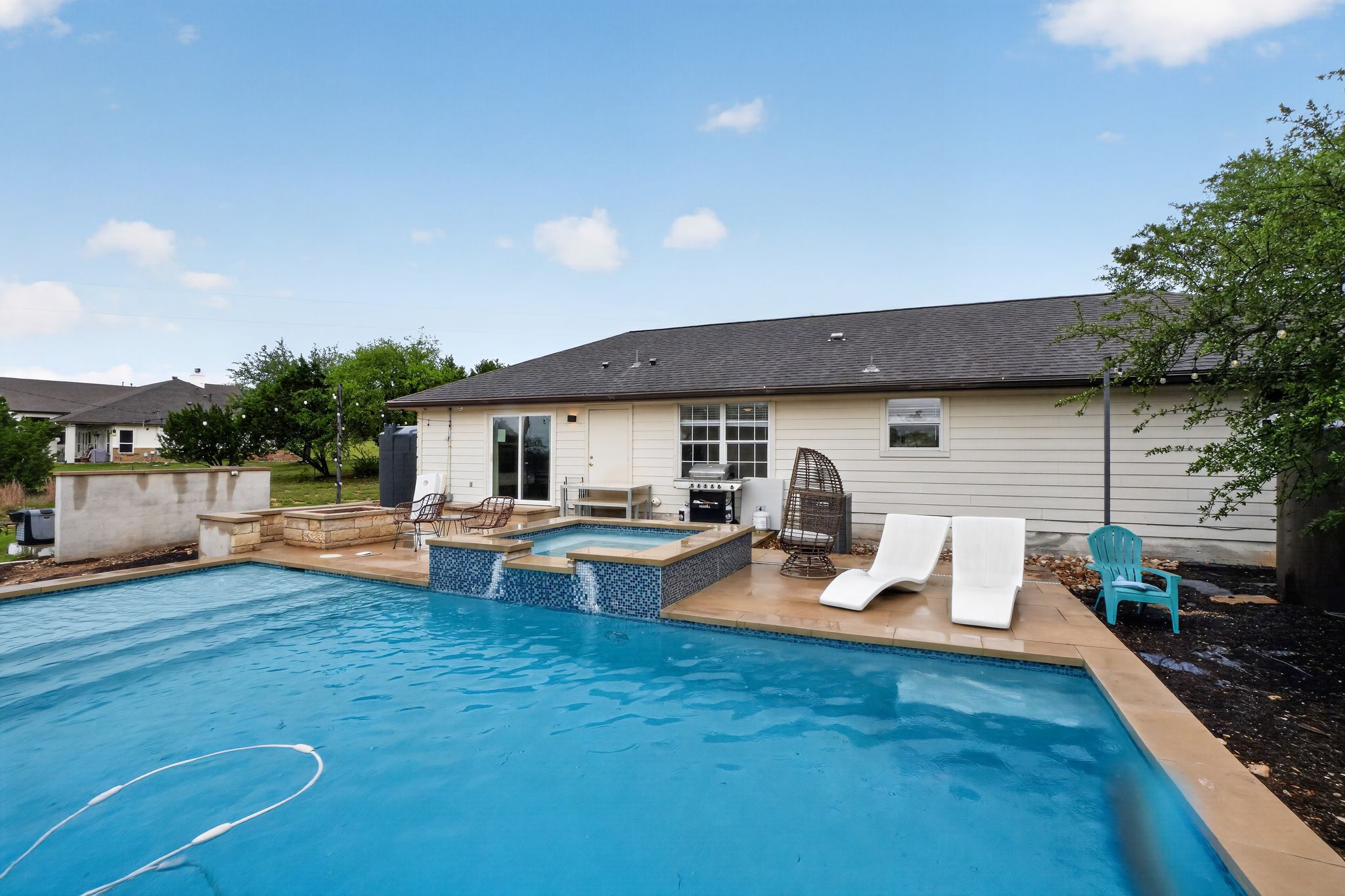 13624 Trautwein Road Austin, TX 78737 - Photo 32 of 38 An inviting backyard oasis offers a sparkling pool with an integrated spa, perfect for relaxation and entertaining.