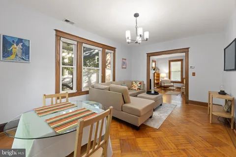 a living room with furniture and a chandelier